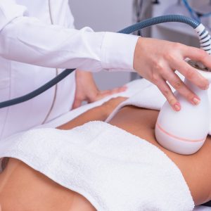 woman doing lipocavitation in the clinic